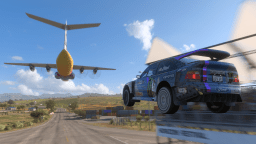 A rally car takes off from a ramp, with a massive cargo plane visible in the background.