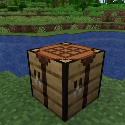 A crafting table is situated beside a river.